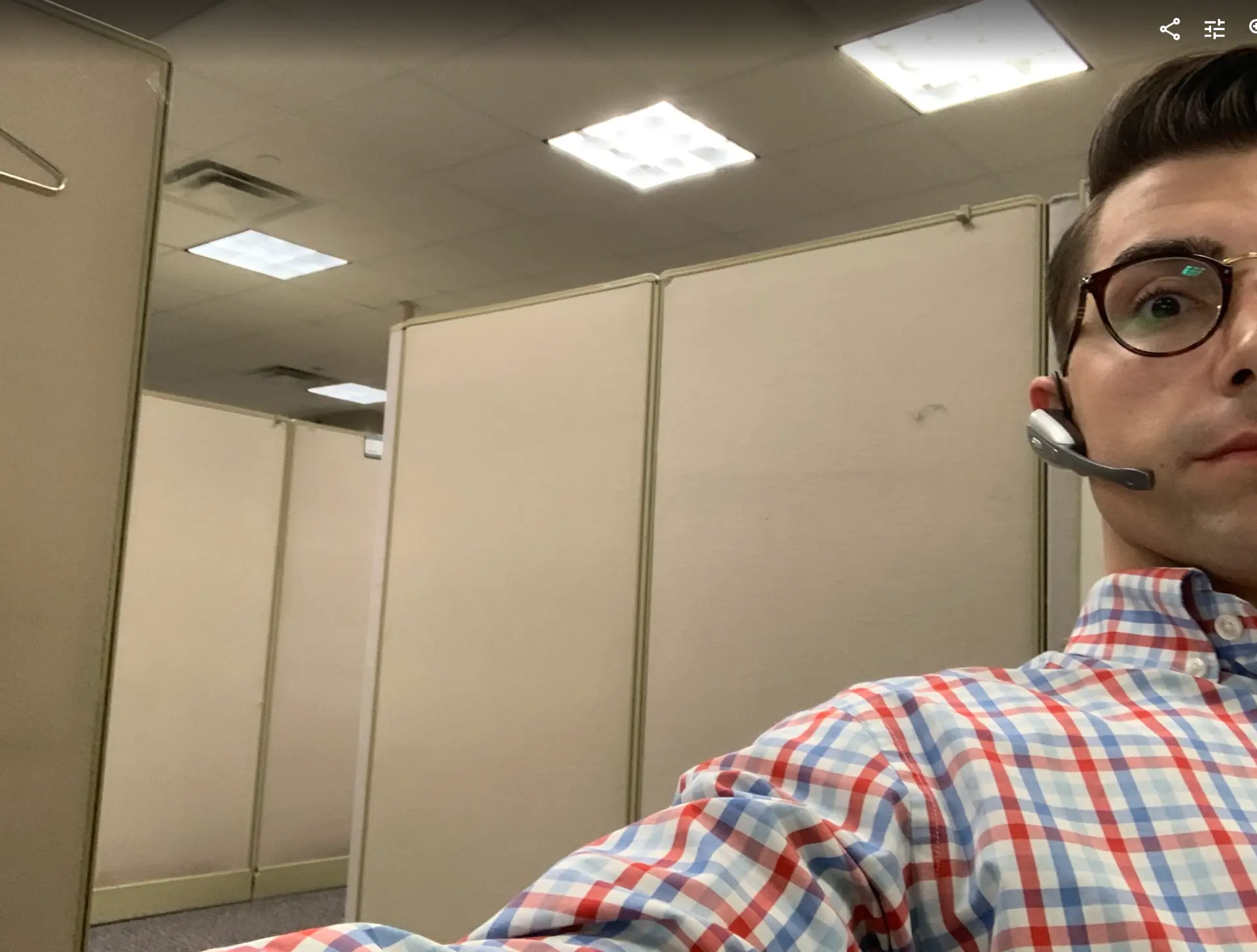 Dalton at his first corporate job in a cubicle with a headset