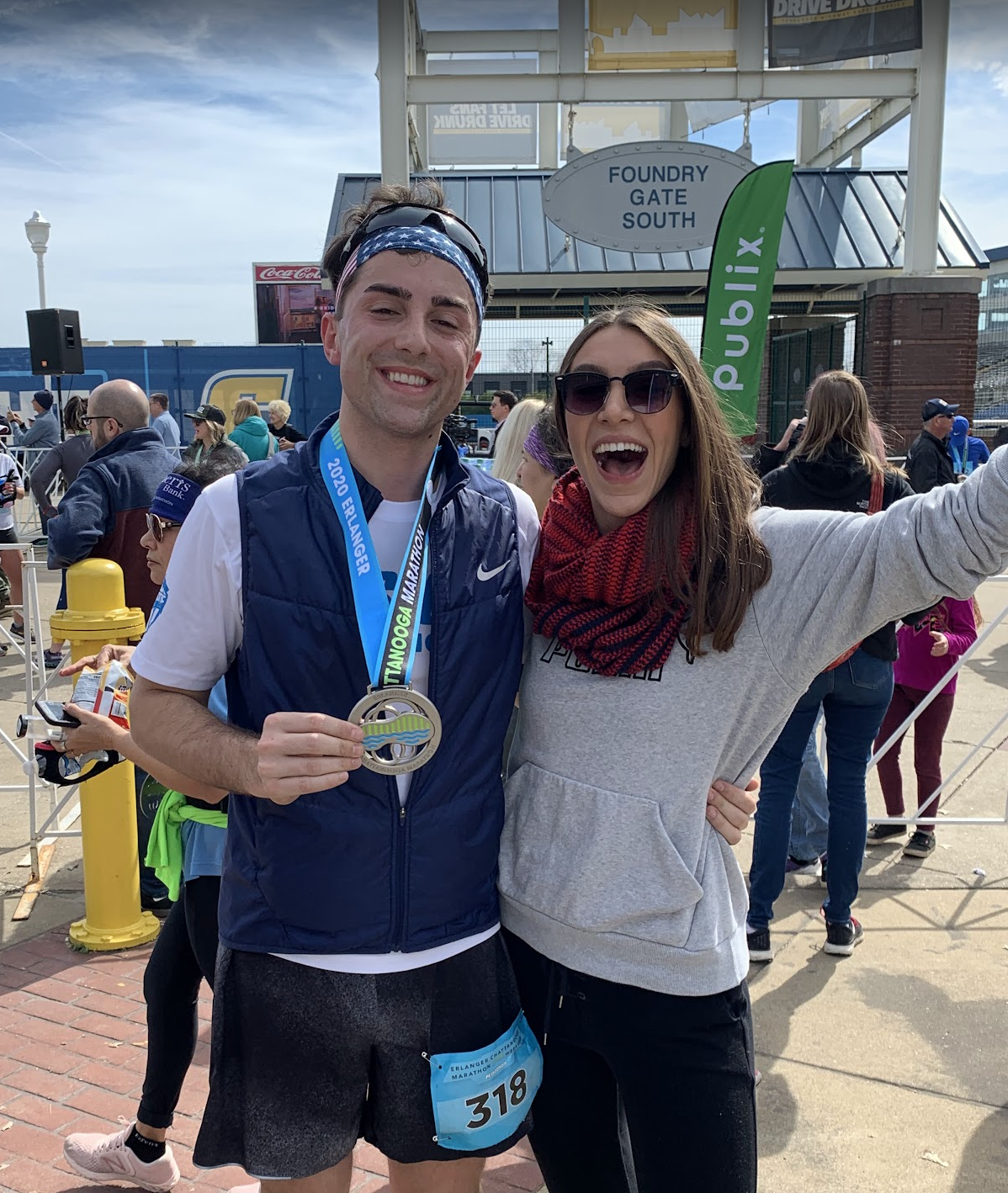 Dalton holding his finisher medal with Amber after the Chattanooga Marathon