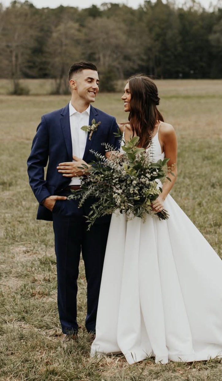 Dalton and Amber on their wedding day in an open field